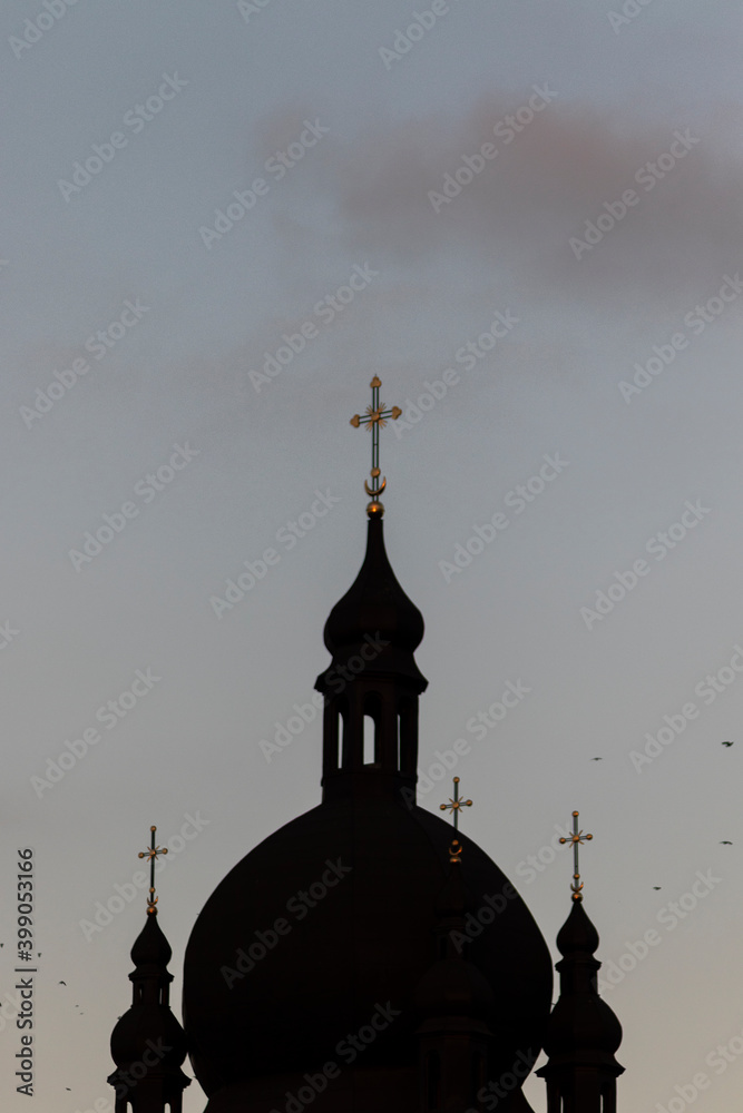 Dark silhouette of the church dome with crosses. Soft focus.