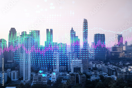 Market behavior graph hologram  sunset panoramic city view of Bangkok  popular location to achieve financial degree in Asia. The concept of financial data analysis. Double exposure.