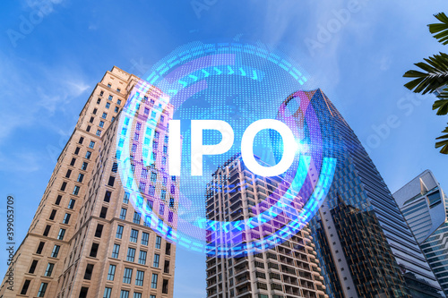 IPO icon hologram on low, wide angle view of glass and steel contemporary skyscrapers in financial downtown. The concept of success in exceeding business opportunities. Double exposure.