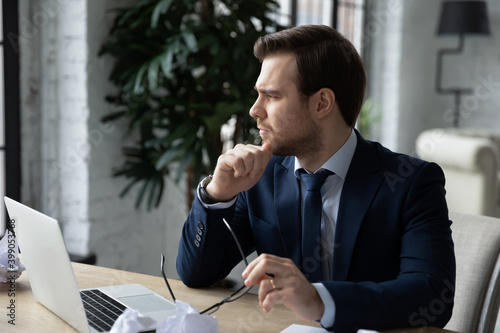 Photos Thoughtful serious businessman taking off glasses distracted from work, sitting