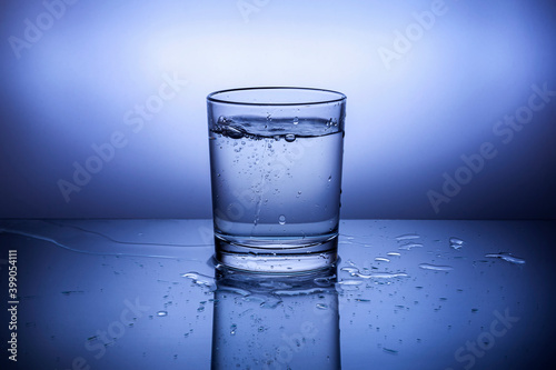 A glass with water on a blue background