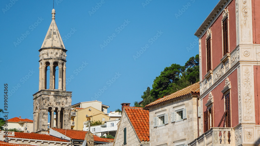 View of the bell tower of Hvar Cathedral of Saint Stephen and house roofs