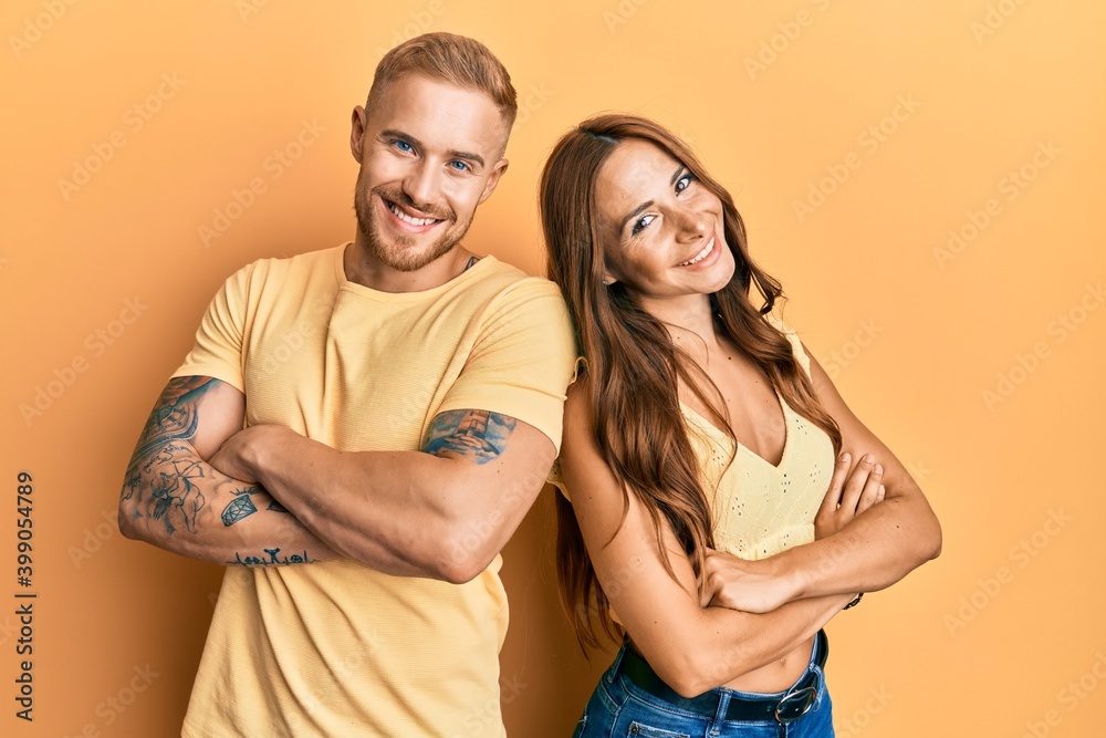 Fototapeta premium Young couple of girlfriend and boyfriend hugging and standing together happy face smiling with crossed arms looking at the camera. positive person.