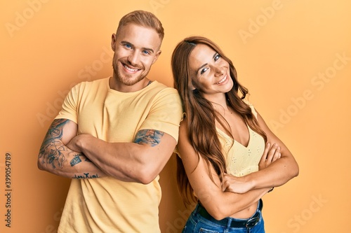 Young couple of girlfriend and boyfriend hugging and standing together happy face smiling with crossed arms looking at the camera. positive person.