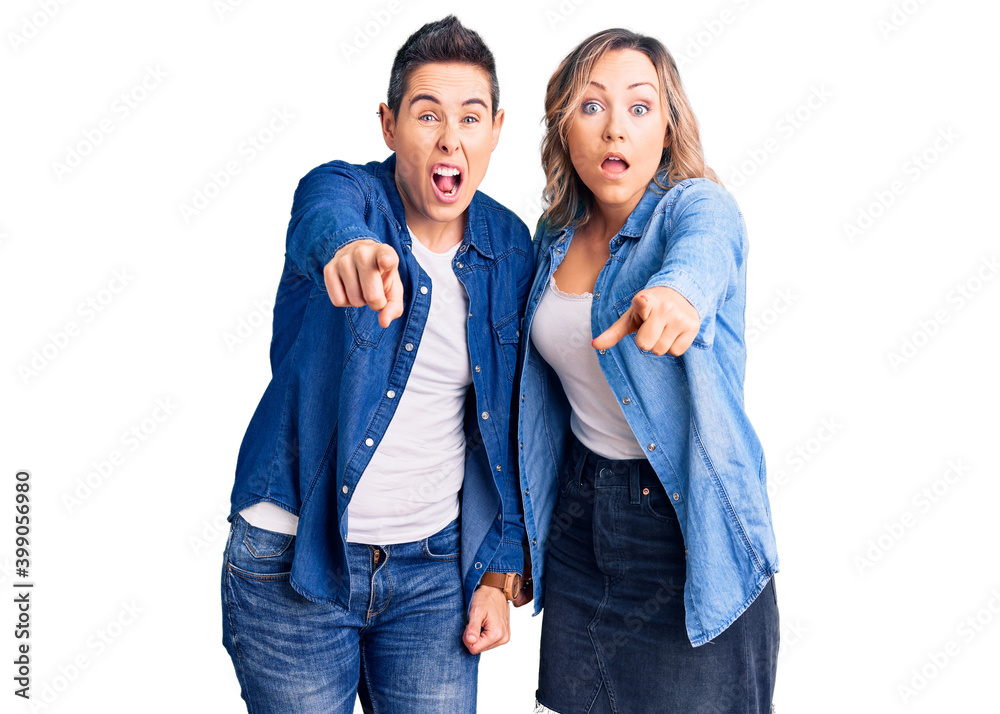Couple of women wearing casual clothes pointing displeased and frustrated to the camera, angry and furious with you