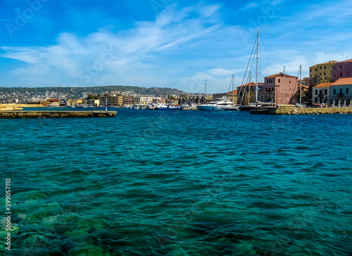 A sea-level view across Chania harbour, Crete on a bright sunny day