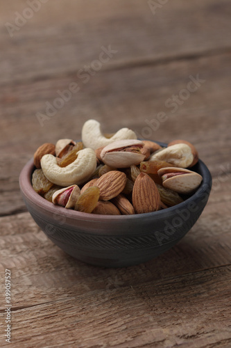 Assorted nuts in a clay bowl. 