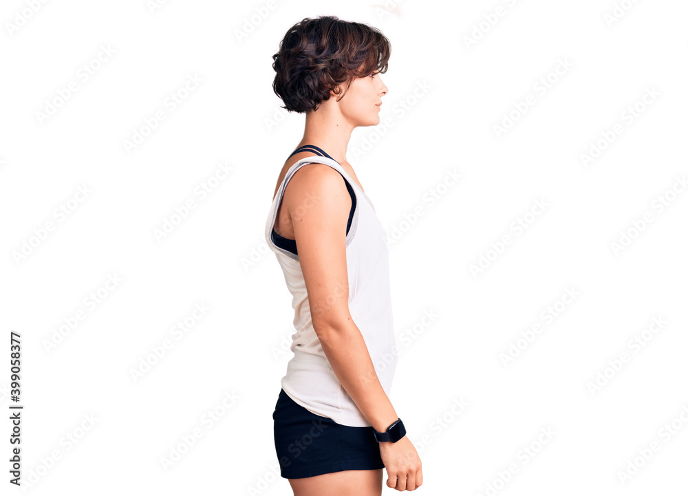 Beautiful young woman with short hair wearing casual sport clothes looking to side, relax profile pose with natural face with confident smile. Beautiful young woman with short hair wearing casual sport clothes looking to side, relax profile pose with natural face with confident smile.
