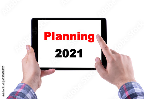 Text Planning 2021 on tablet display. New year!