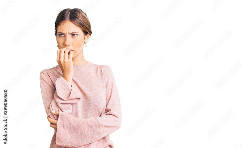 Beautiful caucasian woman with blonde hair wearing casual winter sweater looking stressed and nervous with hands on mouth biting nails. anxiety problem. Beautiful caucasian woman with blonde hair wearing casual winter sweater looking stressed and nervous with hands on mouth biting nails. anxiety problem.