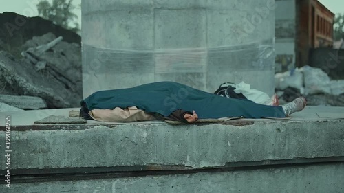 Body of homeless person covered with blanket, homelessness issues, poverty