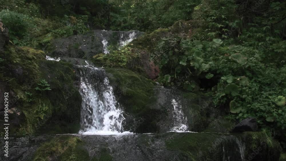 Beautiful waterfall in green forest. Tropical in mountain jungle. Waterfall in the tropical forest in 4k