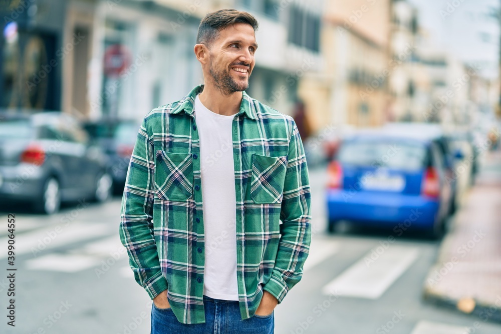 Young caucasian man smiling happy standing at the city. Young caucasian man smiling happy standing at the city.