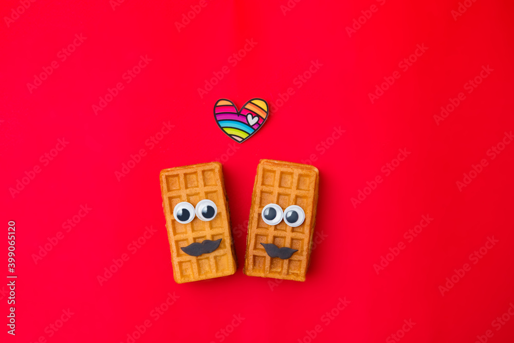 Couple Beauty sweet Viennese waffles on red background. Concept homosexual lgbt love. Creative Valentine's Day Greeting card