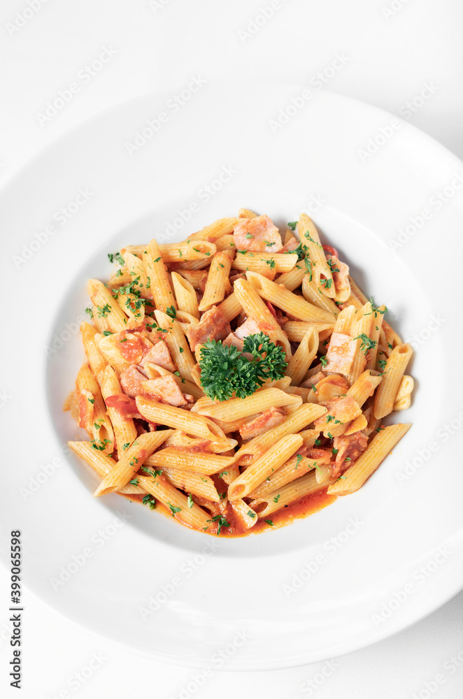 penne amatriciana tomato and ham sauce pasta on white table