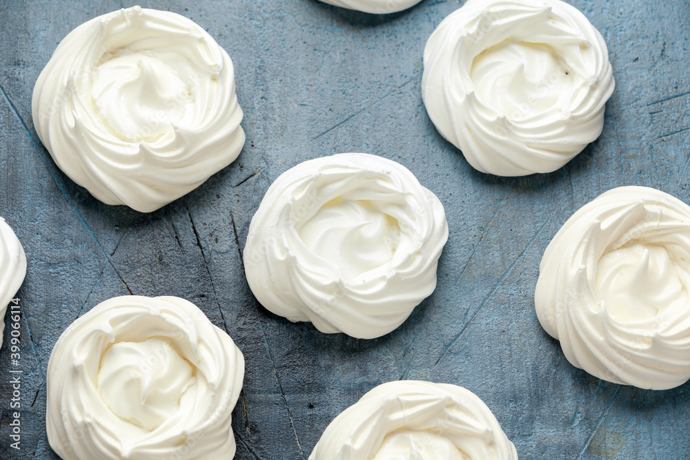 Sweet white meringue on old rustic table Sweet white meringue on old rustic table
