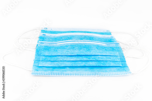 Three blue surgical masks for personal protection against the virus, isolated on a white background.
