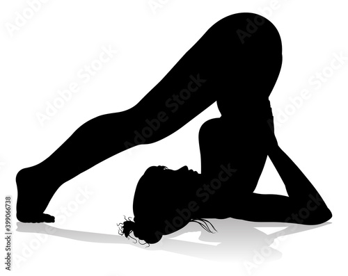 A silhouette of a woman in a yoga or pilates pose
