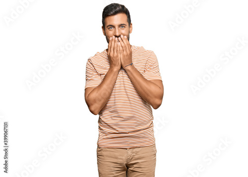 Obraz na płótnie Handsome hispanic man wearing casual clothes laughing and embarrassed giggle cov