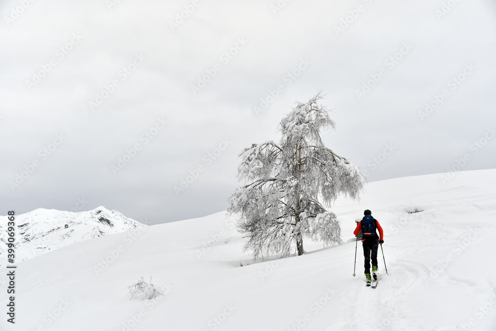 Ascent on skis on the snowy mountain