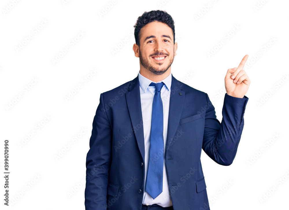 Young hispanic man wearing business clothes smiling happy pointing with hand and finger to the side Young hispanic man wearing business clothes smiling happy pointing with hand and finger to the side