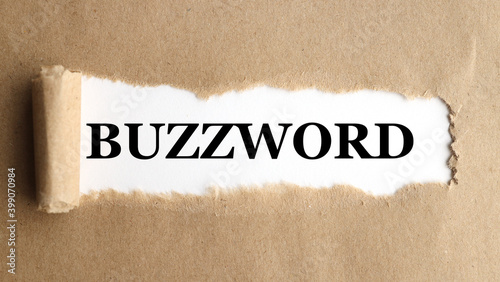 buzzword, text on white paper on torn paper background