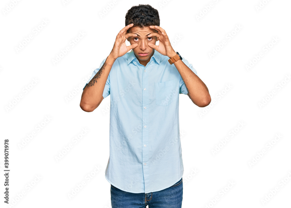 Young handsome african american man wearing casual clothes trying to open eyes with fingers, sleepy and tired for morning fatigue Young handsome african american man wearing casual clothes trying to open eyes with fingers, sleepy and tired for morning fatigue