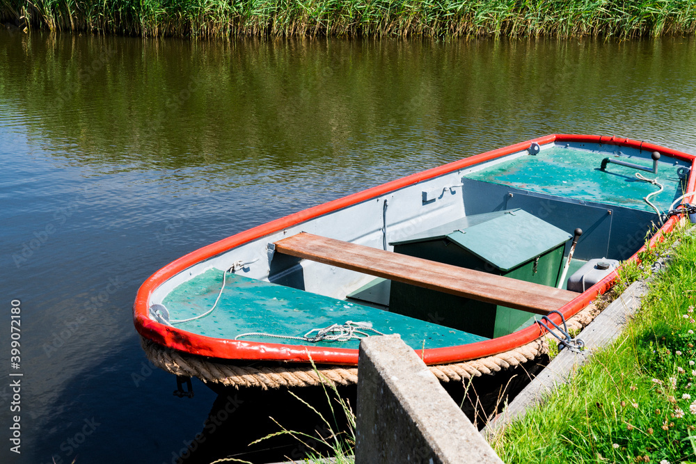 small boat in water. Broek op Langedijk, The Netherlands. small boat in water. Broek op Langedijk, The Netherlands.