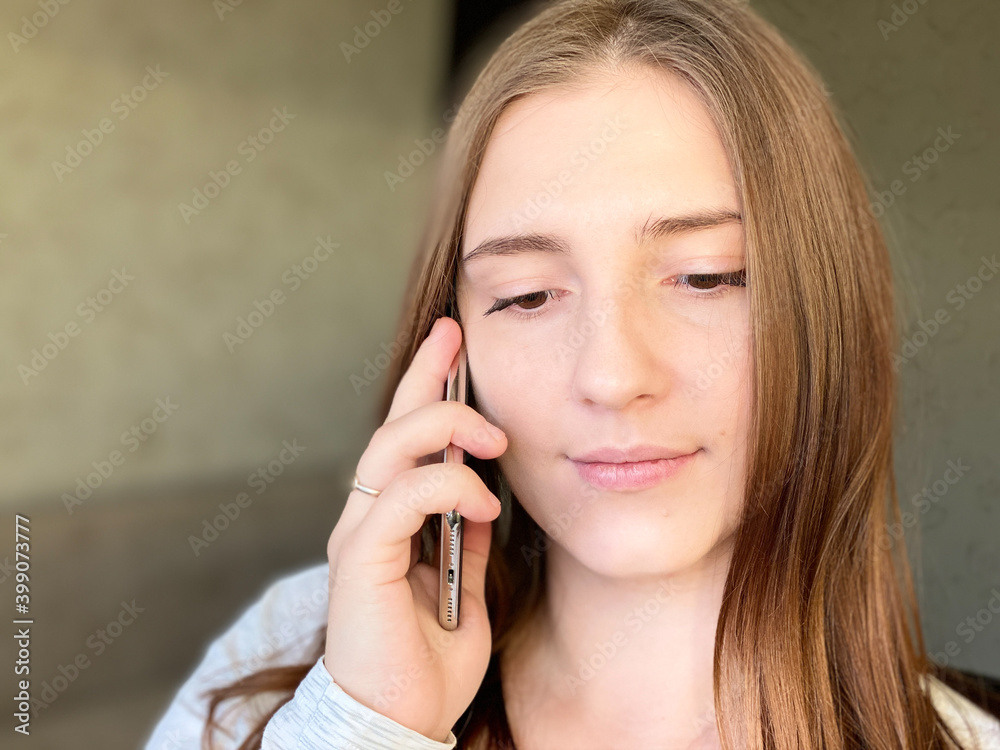 Smiling young female talking cellphone home copy space Smiling young female talking cellphone home copy space
