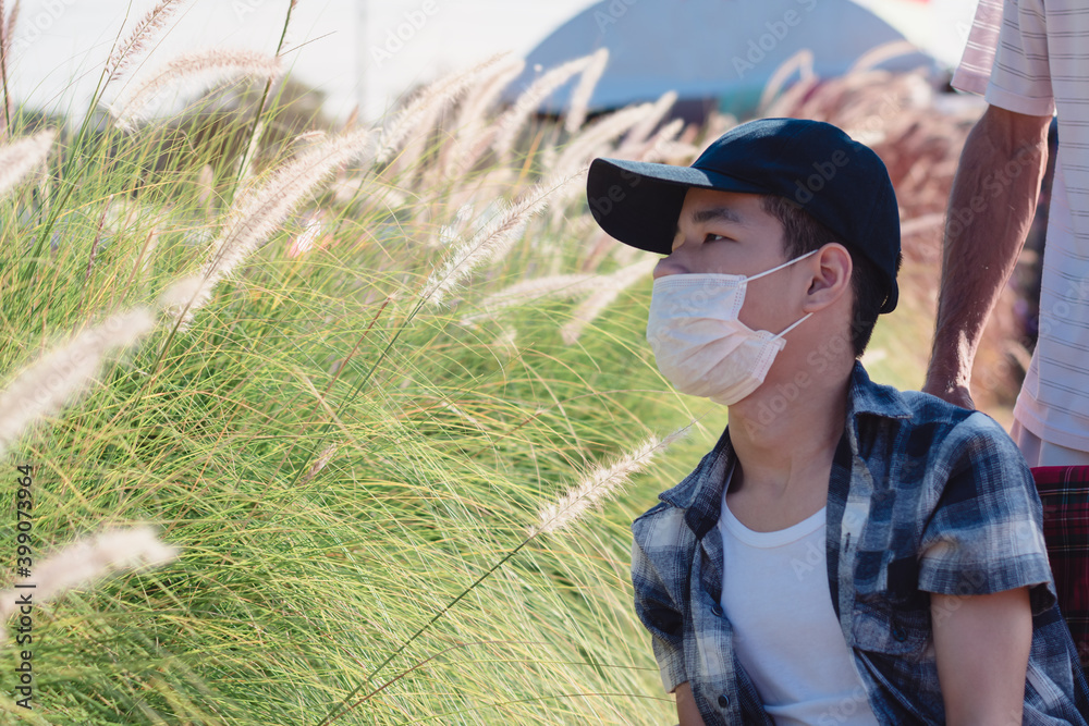 Disabled child on wheelchair is playing, learning and exercise in the outdoor city park like other people with family,Lifestyle of special child,Life in the education age,Happy disability kid concept.