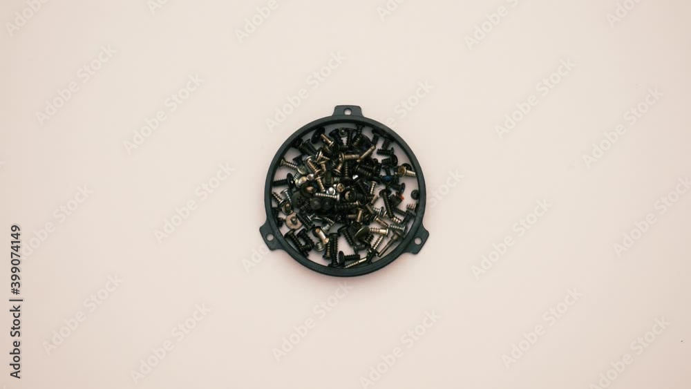 Small pieces of tech elements in motion with magnetic force. Bolts, screw and springs isolated on white background Small pieces of tech elements in motion with magnetic force. Bolts, screw and springs isolated on white background