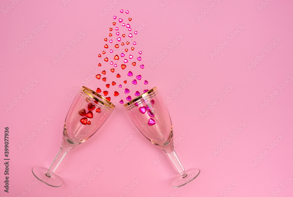 Valentine's Day holiday. Wine glasses on a pink background. Crystals in glasses. Valentine's Day holiday. Wine glasses on a pink background. Crystals in glasses.