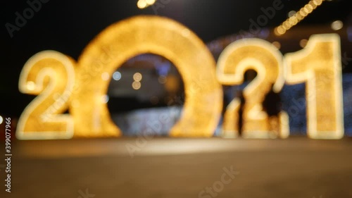 Blurred people walking on decoration night light celebrate happy new years 2021.