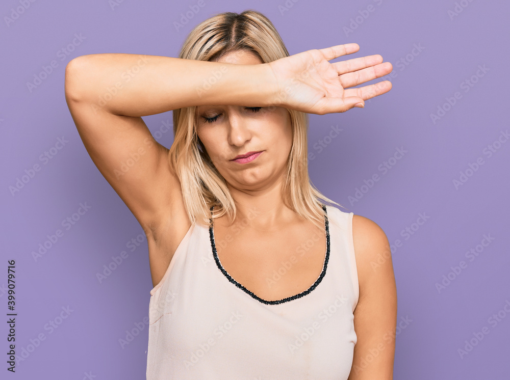 Middle age caucasian woman wearing casual clothes covering eyes with arm, looking serious and sad. sightless, hiding and rejection concept