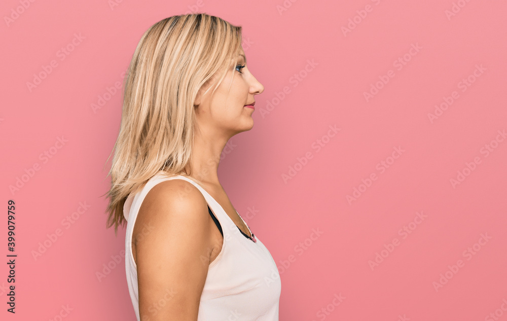 Middle age caucasian woman wearing casual clothes looking to side, relax profile pose with natural face and confident smile. Middle age caucasian woman wearing casual clothes looking to side, relax profile pose with natural face and confident smile.