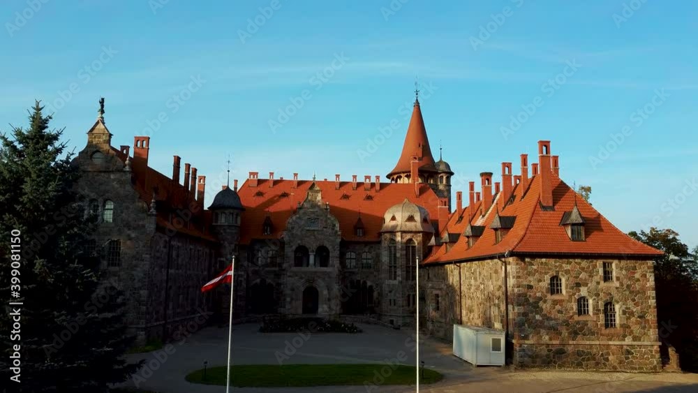 Cesvaine Medieval Castle in Latvia From Above Top View. A Manor House of the Late 19th Century, a Building of Stones With a Brown Tiled Roof. Cesvaine Palace in Beautiful Autumn Day. Aerial Dron 4k S Cesvaine Medieval Castle in Latvia From Above Top View. A Manor House of the Late 19th Century, a Building of Stones With a Brown Tiled Roof. Cesvaine Palace in Beautiful Autumn Day. Aerial Dron 4k S