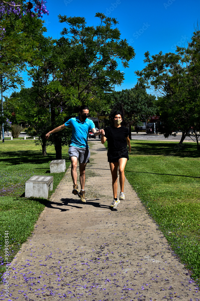 Happy young couple jumping in countryside Happy young couple jumping in countryside