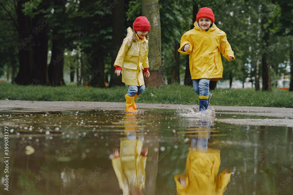 Kids in a puddle. Child having fun outdoors. Kids in a puddle. Child having fun outdoors.