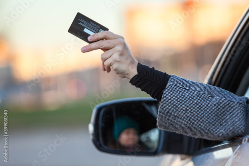 Woman a driver giving her credit card for cashless payment due coronavirus pandemic photo