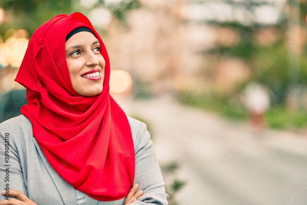 Young arab woman wearing hijab smiling happy at the city. Young arab woman wearing hijab smiling happy at the city.