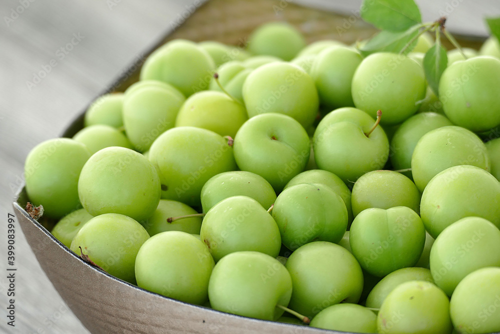 green fresh sour plums and large quantities in the plate, green fresh sour plums and large quantities in the plate,
