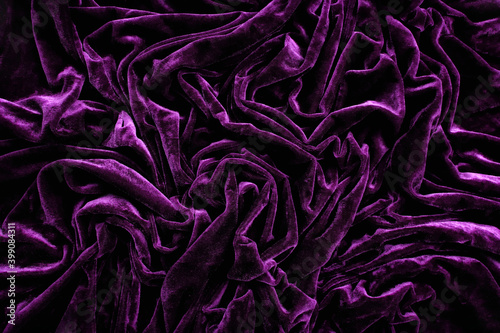Folds of deep purple velvet material, background photo