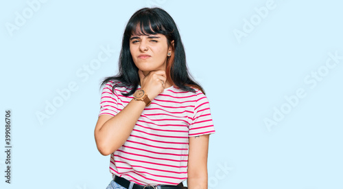 Young hispanic girl wearing casual clothes touching painful neck, sore throat for flu, clod and infection © Krakenimages.com