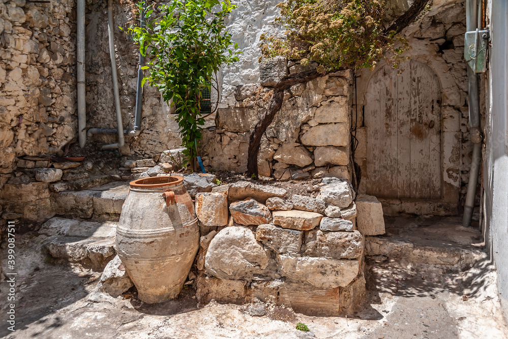 Amphora near the door of an old house Amphora near the door of an old house