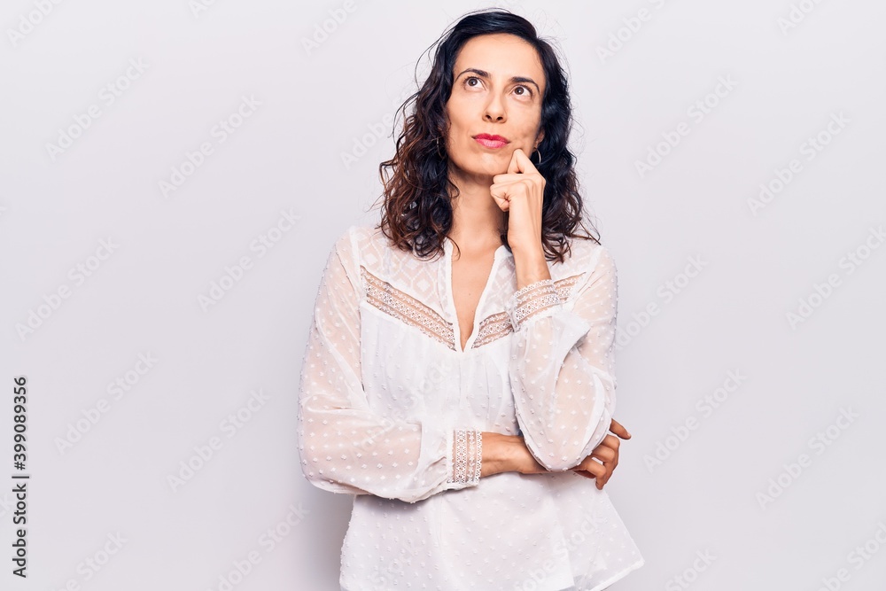 Young beautiful hispanic woman wearing casual clothes serious face thinking about question with hand on chin, thoughtful about confusing idea Young beautiful hispanic woman wearing casual clothes serious face thinking about question with hand on chin, thoughtful about confusing idea