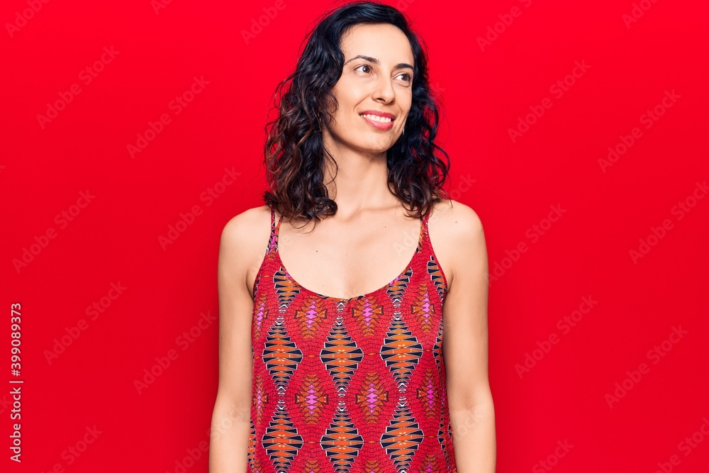 Young beautiful hispanic woman wearing casual clothes looking to side, relax profile pose with natural face and confident smile. Young beautiful hispanic woman wearing casual clothes looking to side, relax profile pose with natural face and confident smile.