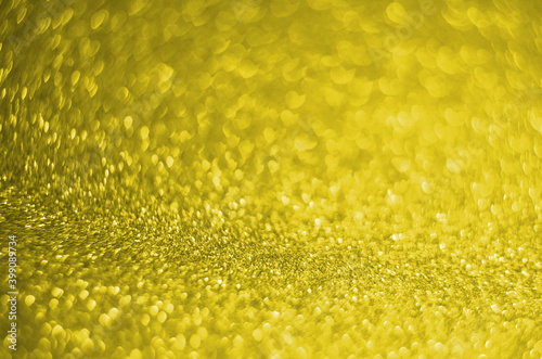 Illuminating Pantone Color Of The Year 2021. Abstract festive bokeh background with shining defocus sparkles. Blurred glitters shimmering dust macro close up, copy space for text logo