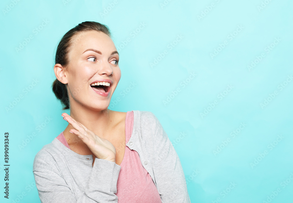 young surprised woman over blue background young surprised woman over blue background