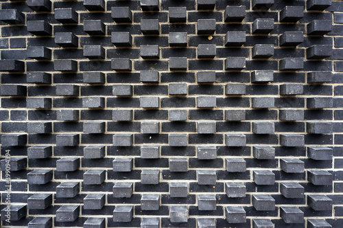 Modern wall made of black bricks. Architectural pattern and background. photo