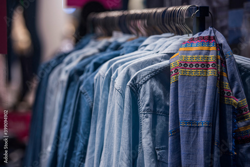 Women clothing on hangers in a mall - shopping in mall concept